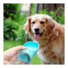 Dog drinking from a compact water cup outdoors