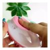 Hand holding a soft silicone dog bath brush