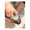 Dog being gently cleaned with a silicone bath brush